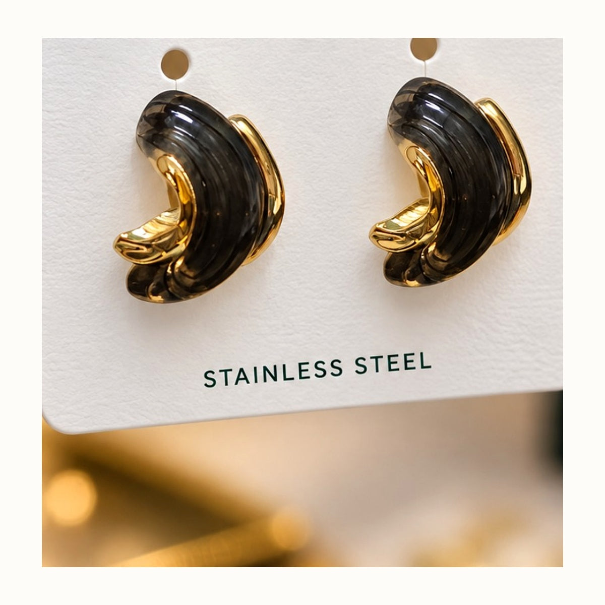 ISHANTRAA Gold Touch Black and Gold Curve Stainless Steel Earrings - close-up