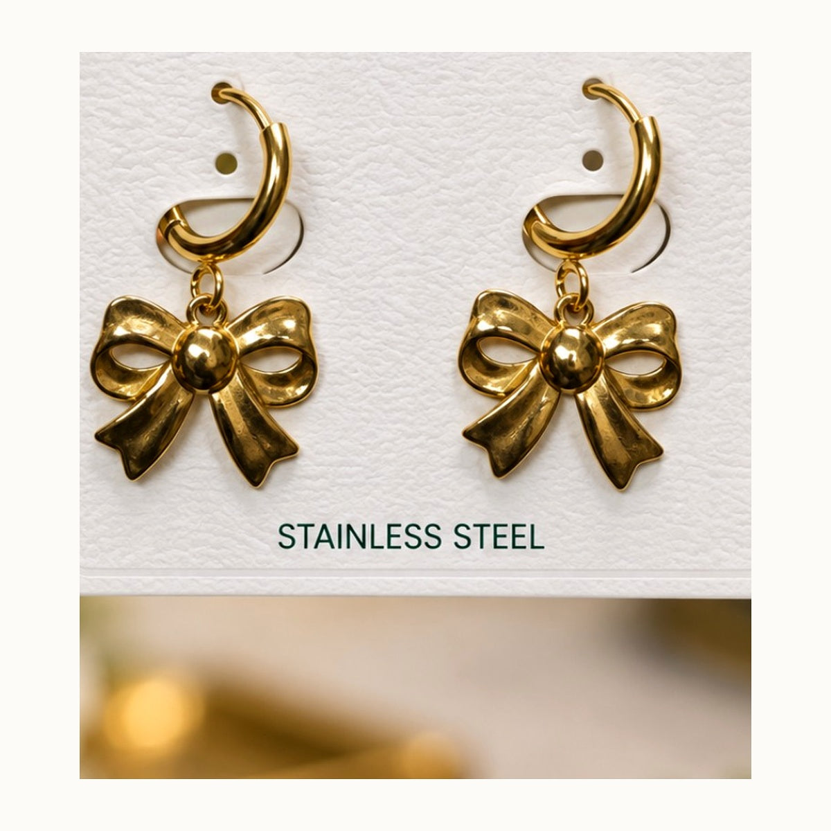 ISHANTRAA Gold Touch Bow Drop Stainless Steel Earrings - close-up